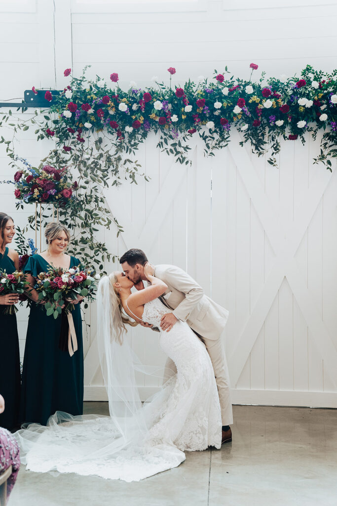 indoor wedding at Sixpence Wedding Venue, first kiss