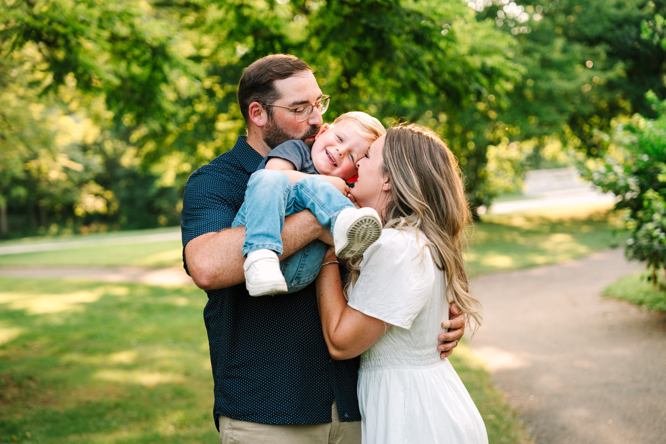 Family playing tag during outdoor photo session at a park in Evansville, Indiana by Brittney Moseby Photography