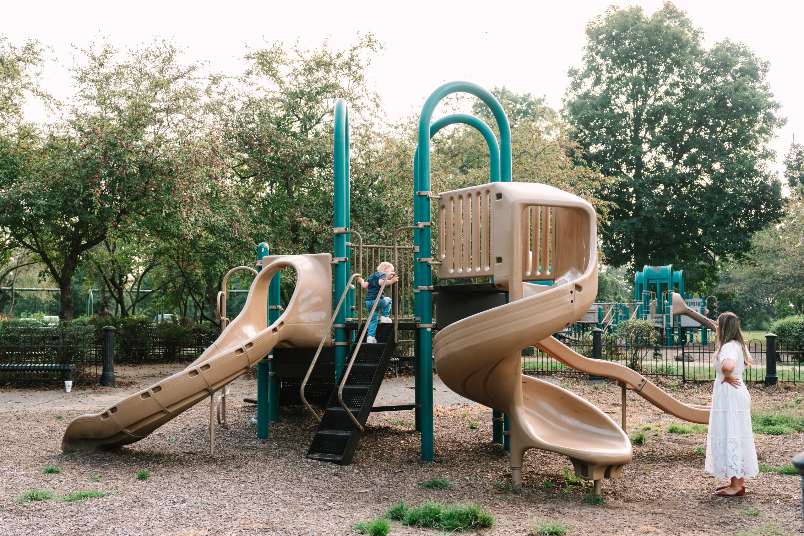 Family playing tag during outdoor photo session at a park in Evansville, Indiana by Brittney Moseby Photography